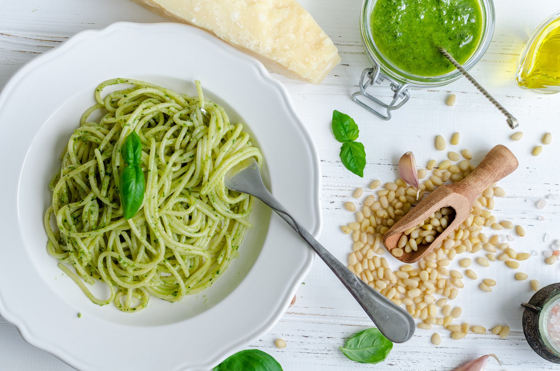 Plate of homemade pesto sauce on linguine with pine nuts and basil