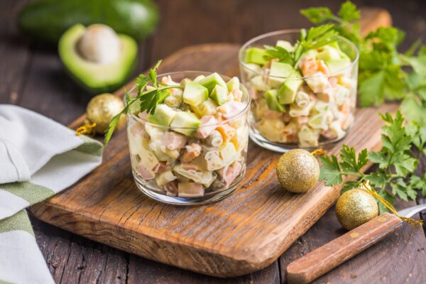 Russian traditional salad Olivier with vegetables in glasses. Winter Christmas salad