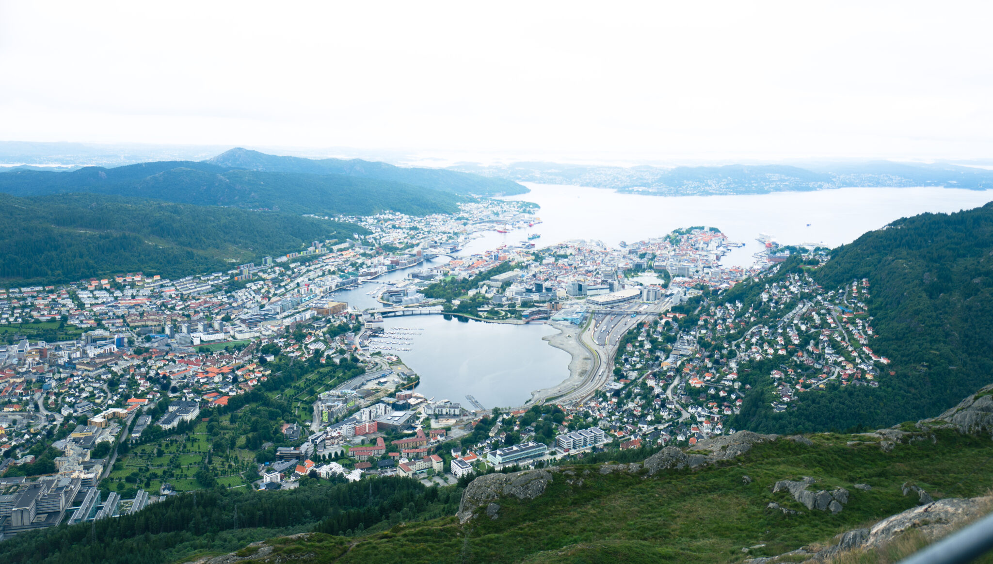 View onto a harbor in the fjords from on top a mountain.